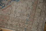 Distressed vintage Malayer rug texture with faded Herati motifs, sky blue and terra cotta tones.