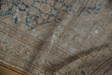 Distressed texture of vintage Malayer rug, with threadbare beige pile and visible foundation.