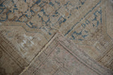 Distressed Malayer rug pile with exposed foundation and striped hand-knotted backing.