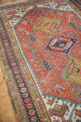 Vintage Heriz rug field detail: madder root rust geometric motifs and seed design border.