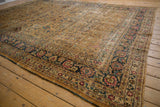 Distressed Meshed rug corner, showing camel field with faded scrolling vinery and palmette border.