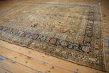 Distressed vintage Meshed carpet corner, showing navy blue palmette and meandering vine border.
