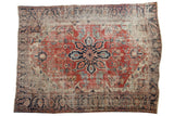 Antique Serapi carpet: brick red field, navy starburst medallion, time-worn geometric botanical motifs. 9'6