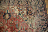 Antique Serapi carpet detail: navy blue ground, ivory serrated leaves, and visible foundation wear.