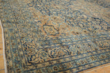 Muted navy and sand floral vinery on a vintage Meshed carpet with mostly even wear.