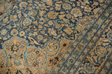 Detail of distressed vintage Meshed carpet: navy blue and sand floral arabesques.