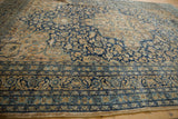 Distressed Meshed rug border with navy blue, sand, and muted teal floral vinery.