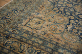 Vintage Distressed Meshed carpet with faded navy, sand floral arabesques and worn texture.