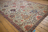 Antique Mahal carpet with visible foundation wear on ivory field, adorned with blooming vinery.