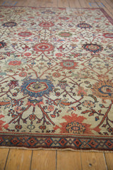 Worn floral motifs, vinery, and lotus flowers on an ivory Antique Mahal carpet. Visible foundation.