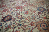 Antique Persian Mahal close-up: intricate floral motifs, scrolling vinery, visible pile wear.