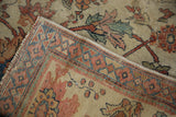 Antique Mahal carpet corner, showing threadbare pile, exposed foundation, and intricate border.