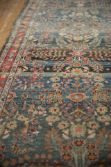 Distressed vintage Dargezine runner's intricate thousand flower blossom motif in denim blue and pale red.