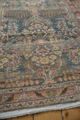 Distressed pile with intricate thousand blossom motif in denim blue, soft red, and ivory.