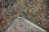 Distressed floral motif and visible hand-knotted foundation of the Dargezine runner.