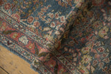 Distressed vintage Dargezine runner's textured pile with blue and blush thousand flower blossoms.