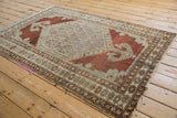 Distressed Malayer rug's faded chestnut brown and pale dusty slate blue design.