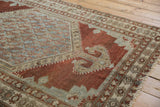 Distressed Malayer rug corner detail, bold finial on copper field with slate blue and wear.