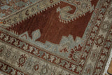 Distressed Persian Malayer rug border with worn chestnut field and geometric slate blue patterns.