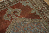 Distressed copper field with detailed slate blue patterns and borders on this Malayer rug.
