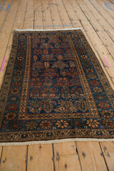 Vintage Hamadan rug's detailed borders, deep sapphire blue field, and repeating boteh motifs.