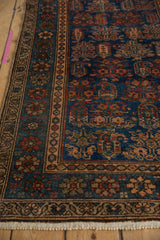 Deep sapphire blue field, madder red boteh, and detailed patterned borders of the Hamadan rug.