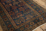 Deep sapphire field of Hamadan rug with madder red boteh and coffee brown border.