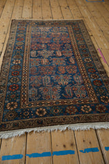 Deep sapphire blue field and repeating boteh with plant motifs on this Hamadan rug.