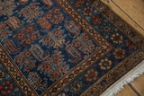Vintage Hamadan rug corner showing deep sapphire blue boteh field, coffee brown borders, ivory fringe.