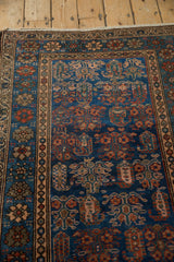 Hamadan rug detail: deep sapphire field, repeating madder root red boteh and plant motifs.