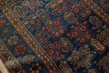 Hand-knotted deep sapphire blue field with repeating boteh and plant motifs.