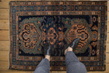 A personal perspective of a vintage Malayer rug, highlighting the scale of its triple medallion design.