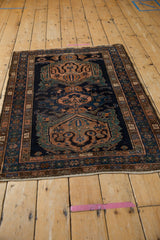 Angled perspective of the vintage Malayer rug showing its full length and triple medallion design.