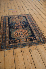 Vintage Malayer rug from an angled perspective, showing the full length of its triple medallions.