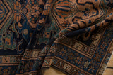 A close-up view of the vintage Malayer rug's hand-knotted pile and geometric border design.