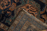 A folded corner of the vintage Persian Malayer rug reveals its hand-knotted construction.