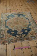 Distressed Malayer rug corner, worn pile and knot heads with fringe, dusty navy, rose.