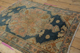 Frayed fringe and worn dusty rose border of a vintage Distressed Malayer rug with low pile.