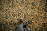 Distressed Persian Meshed rug's camel field, delicate blue and bronze floral vinery, and rich border.