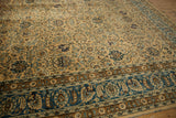 Distressed vintage Meshed rug border with sky blue and camel floral motifs.