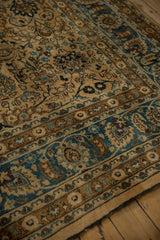 Distressed vintage Meshed rug corner with camel field, sky blue, and bronze floral patterns.