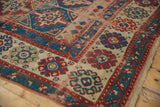 Storied wear on a geometric Antique Caucasian rug with ram's horn motifs and floral border.