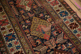 Antique Kuba rug's geometric birds, madder red and navy hues, with moth etching.