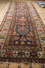 Short, worn fringe and multi-patterned guard borders of an antique Kuba runner rug.