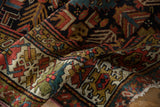 Antique Kuba runner's textured pile, rich madder red, ivory, navy geometric motifs, irregular edge.