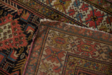Intricate hand-knotted weave and geometric patterns on antique Caucasian Kuba runner's reverse.