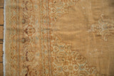 Distressed Indian Tabriz carpet edge with faded Herati motifs and worn pile.