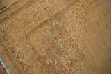 Distressed Indian Tabriz design carpet corner with ornate pattern, worn pile, and muted earth tones.