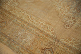 Distressed ivory, beige, and copper curvilinear pattern on vintage Indian Tabriz rug.