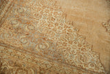 Distressed hand-knotted pile with ivory, copper, and slate Herati motifs in the spandrel.